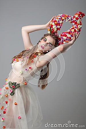 Upright girl with flower horns. Stock Photo