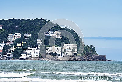 Upscale houses on a hillside by the sea Stock Photo