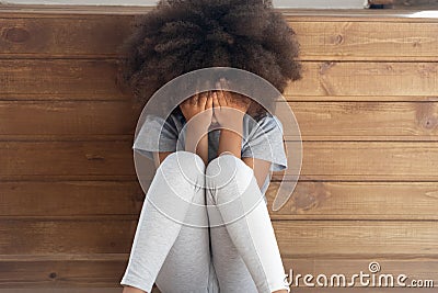 Sad biracial small girl sit on floor crying Stock Photo