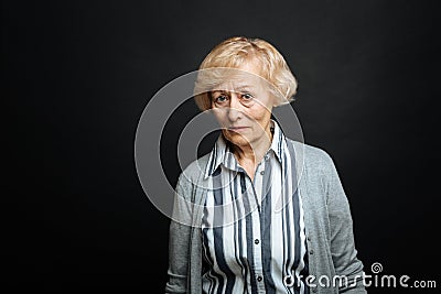 Upset aged pensioner expressing pity indoors Stock Photo