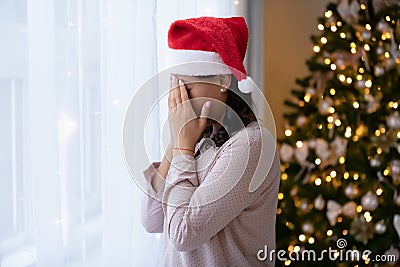 Upset biracial woman feel lonely on Christmas Eve Stock Photo