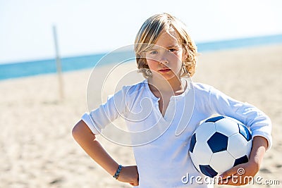 Upset boy holding soccer ball outdoors. Stock Photo