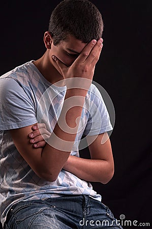 Upset caucasian teenager with hand on head Stock Photo