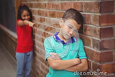 Upset child being teased by another child Stock Photo