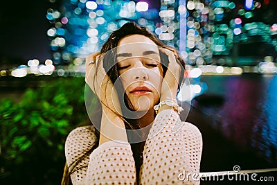 Confused woman portrait standing outdoors at night Stock Photo
