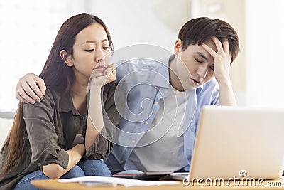 Upset couple frustrated troubled with paying bills expenditures Stock Photo