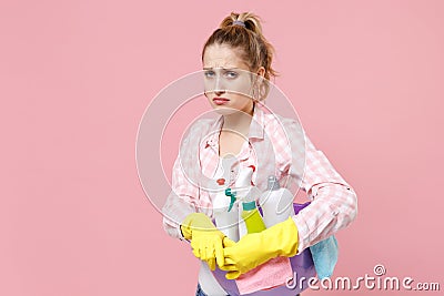 Upset crying young woman housewife in rubber gloves hold basin with detergent bottles washing cleansers while doing Stock Photo