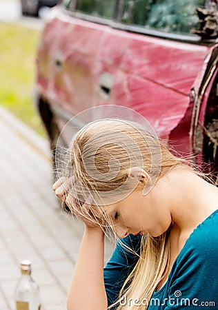 Upset driver woman in front of automobile crash car. Stock Photo