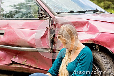 Upset driver woman in front of automobile crash car. Stock Photo