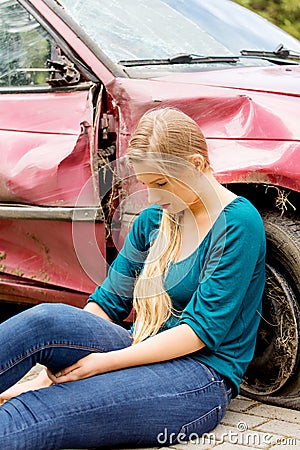 Upset driver woman in front of automobile crash car. Stock Photo