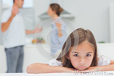 Upset girl listening to parents quarreling Stock Photo