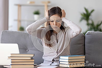 Upset girl student worried making mistake studying Stock Photo