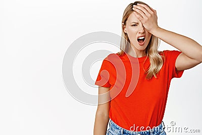 Upset gloomy girl, facepalm, looking frustrated and disappointed, facing failure, losing, forgot smth, standing Stock Photo