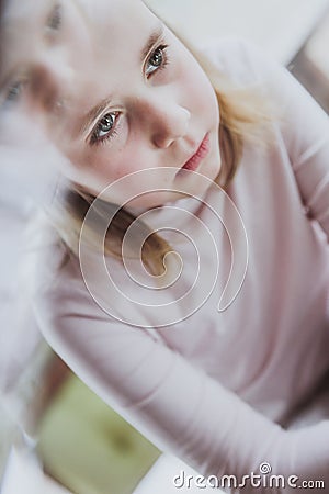 Upset little girl looking away feels lonely Stock Photo