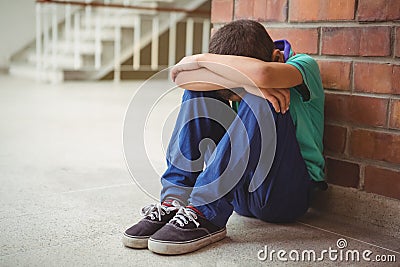 Upset lonely child sitting by himself Stock Photo