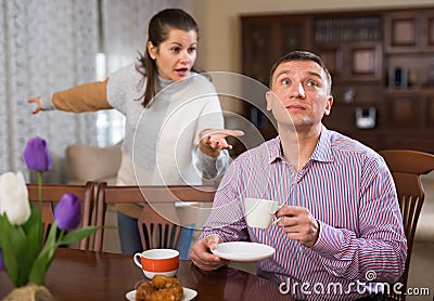 Upset man and frustrated woman arguing at home Stock Photo