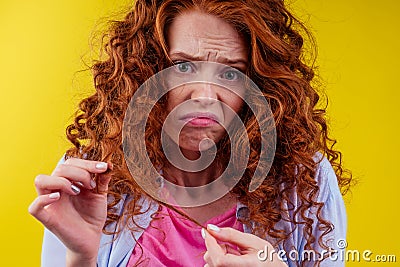 Upset redhaired ginger foxy woman with dryness tangled red hair Stock Photo