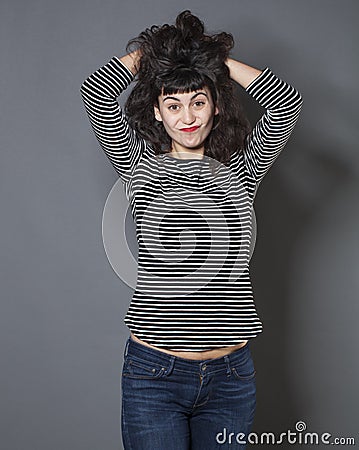 Upset 20s girl expressing embarassment with hair and hand gesture Stock Photo