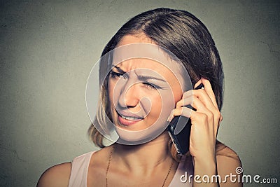 Upset sad annoyed unhappy woman talking on cell phone Stock Photo