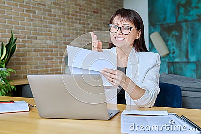 Upset sad business woman reading an official letter Stock Photo