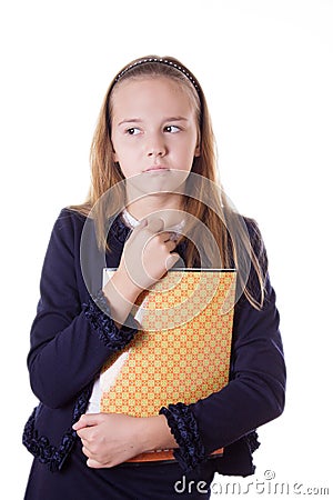 Upset schoolgirl in uniform and books looking aside Stock Photo