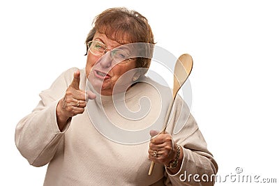 Upset Senior Woman with The Wooden Spoon Stock Photo