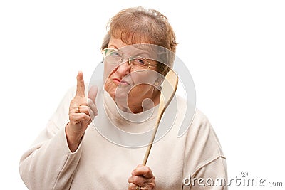 Upset Senior Woman with The Wooden Spoon Stock Photo