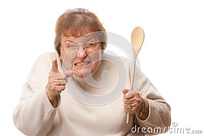 Upset Senior Woman with The Wooden Spoon Stock Photo