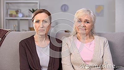 Upset senior women looking camera, social insecurity, pension reform, crisis Stock Photo