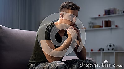 Upset soldier remembering terrifying war, suffering ptsd, psychological help Stock Photo