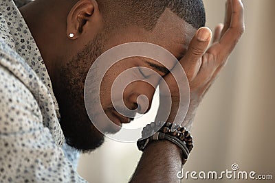 Upset stressed young african american man coping with strong headache Stock Photo