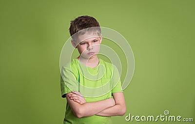 Upset unhappy angry kid with arms crossed, scratch on his face, Stock Photo