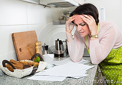 Upset woman reading bank documents Stock Photo