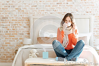 Upset young woman suffering from influenza at home Stock Photo