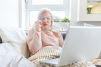 Upset young woman using online banking service, problem with blocked credit card, using laptop, irritated girl checking balance, Stock Photo