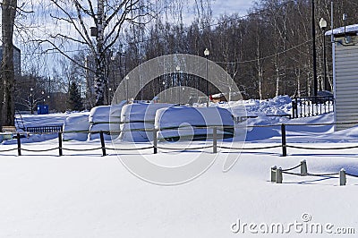 Upside-down snow-covered boats Stock Photo
