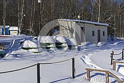 Upside-down snow-covered boats Stock Photo