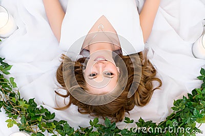 An upside down top view on a lying smiling girl Stock Photo