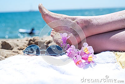 Upside woman feet and red pedicure wear pink sandals, sunglasses at seaside. Funny and happy fashion young woman relax on vacation Stock Photo