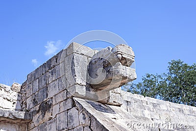 Upward view of the stone jaguar head statue at the Platform of the Eagles and Jaguars in Mayan Ruins of Chichen Itza, Mexico Stock Photo