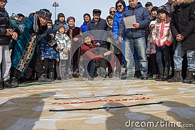 Nauryz holiday in Kazakhstan. Kazakh national game Asyk atu on the Nauryz holiday. Editorial Stock Photo