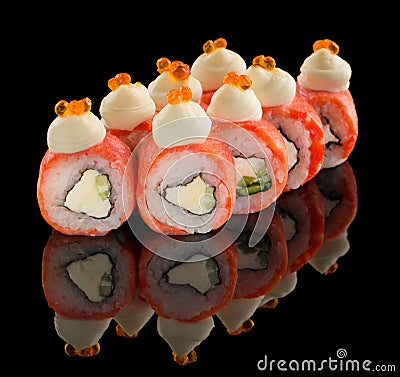 Uramaki Sushi roll with salmon, cheese, cucumber, sauce and caviar on top isolated on black background with reflection Stock Photo