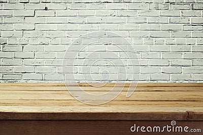 Urban background with empty wooden table and brick wall Stock Photo