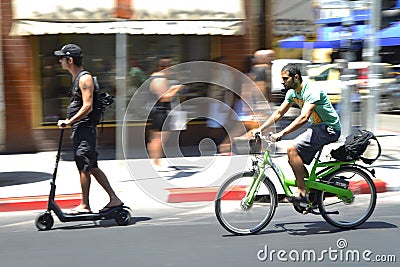 Urban biker and Kick scooter in Tel Aviv, Israel Editorial Stock Photo