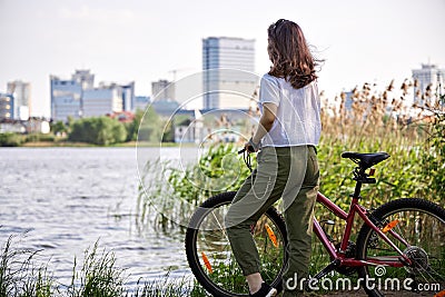 Urban biking teenage girl, bike in city Stock Photo