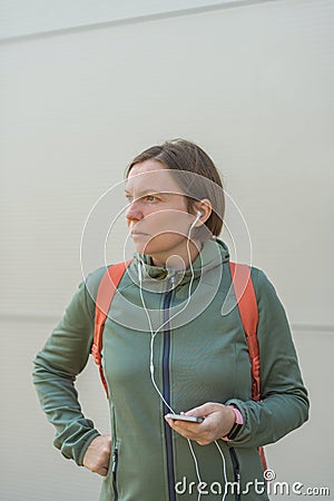 Urban brisk walker female listening music on earphones Stock Photo