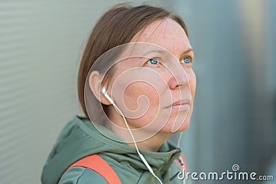 Urban brisk walker female listening music on earphones Stock Photo