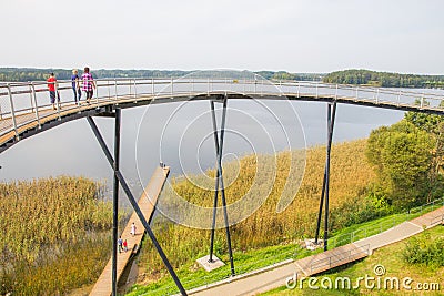 Urban city and peoples. Iron bridge on the lake. Green nature an Editorial Stock Photo