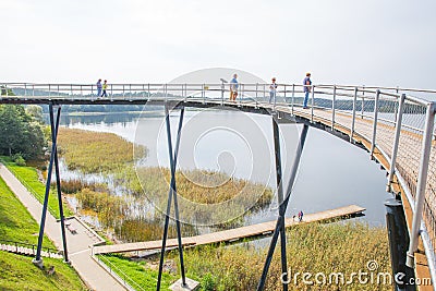 Urban city and peoples. Iron bridge on the lake. Green nature an Editorial Stock Photo