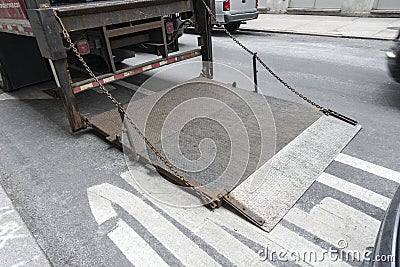 Urban city street back of shipping struck stainless steel power Stock Photo